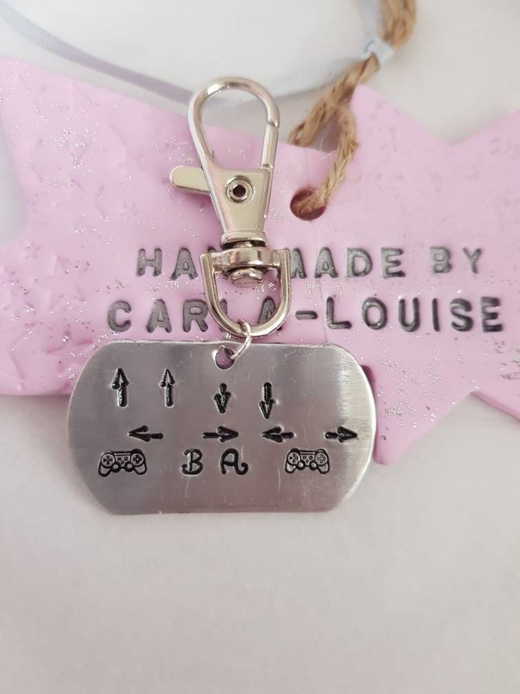 Gamers keyring. Handstamped with a PS cheat code.